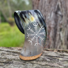 etched tankard on log